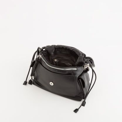 A black leather shoulder bag with a drawstring closure and a silver-tone front snap button, shown open to reveal its interior compartments on a clean white background.