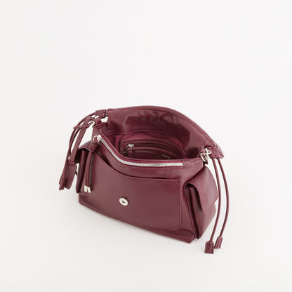 A burgundy leather shoulder bag with a drawstring closure and silver-tone hardware, shown from an elevated angle on a white background.